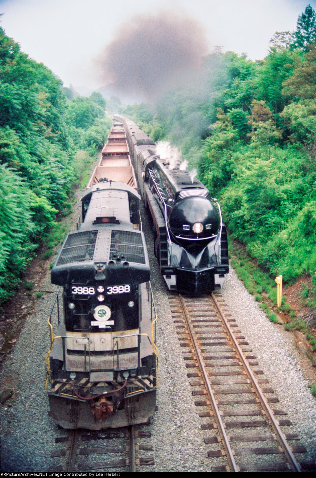 SOU 3988 being passed by N&W 611